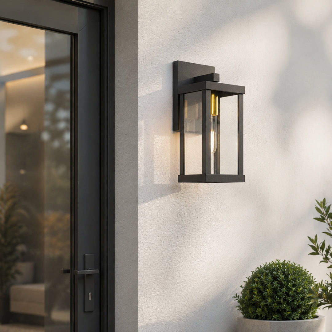 Black metal outdoor wall light lifestyle image with warm glow for elegant exterior entryway decor.