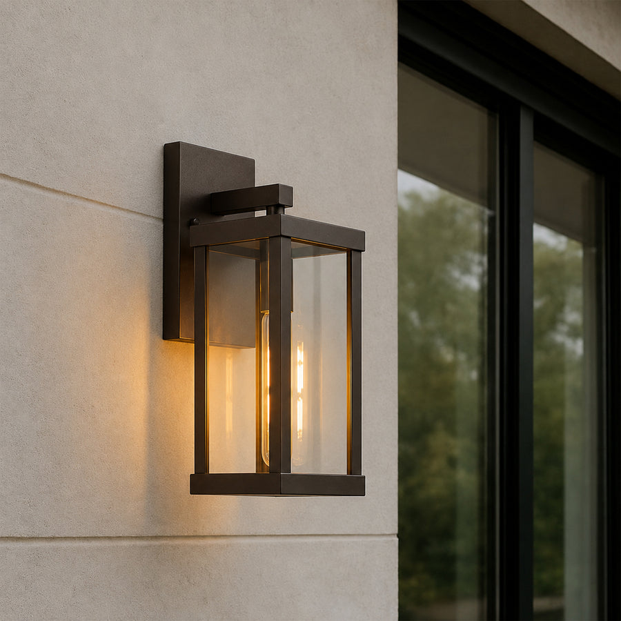 Black metal outdoor wall light lifestyle image with warm glow for modern exterior entryway lighting decor.