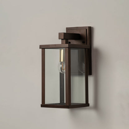 Sleek metal wall lantern on white background with clear glass panels highlighting modern outdoor wall lighting decor.