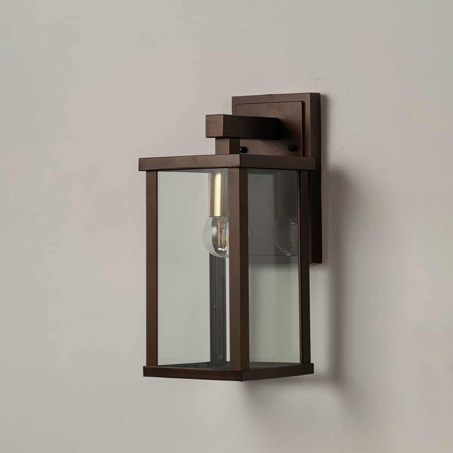 Sleek metal wall lantern on white background with clear glass panels highlighting modern outdoor wall lighting decor.