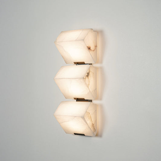 Contemporary wall sconce with layered frosted glass elements creating soft ambient glow perfect for stylish home decor lighting.

