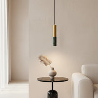 Black and gold metal pendant light above accent table bringing minimalist style to modern home decor.