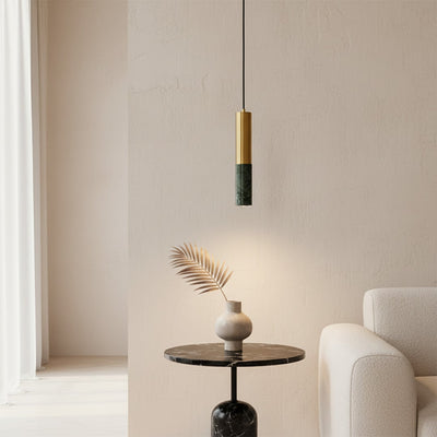 Black and gold metal pendant light above accent table bringing minimalist style to modern home decor.
