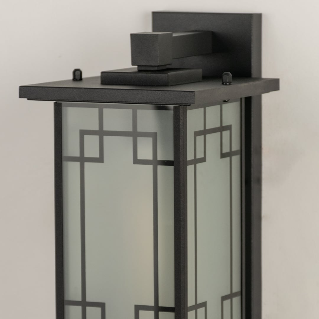 Closeup of gold outdoor lantern showing decorative glass detailing and textured metal frame ideal for classic outdoor porch patio and entryway lighting.