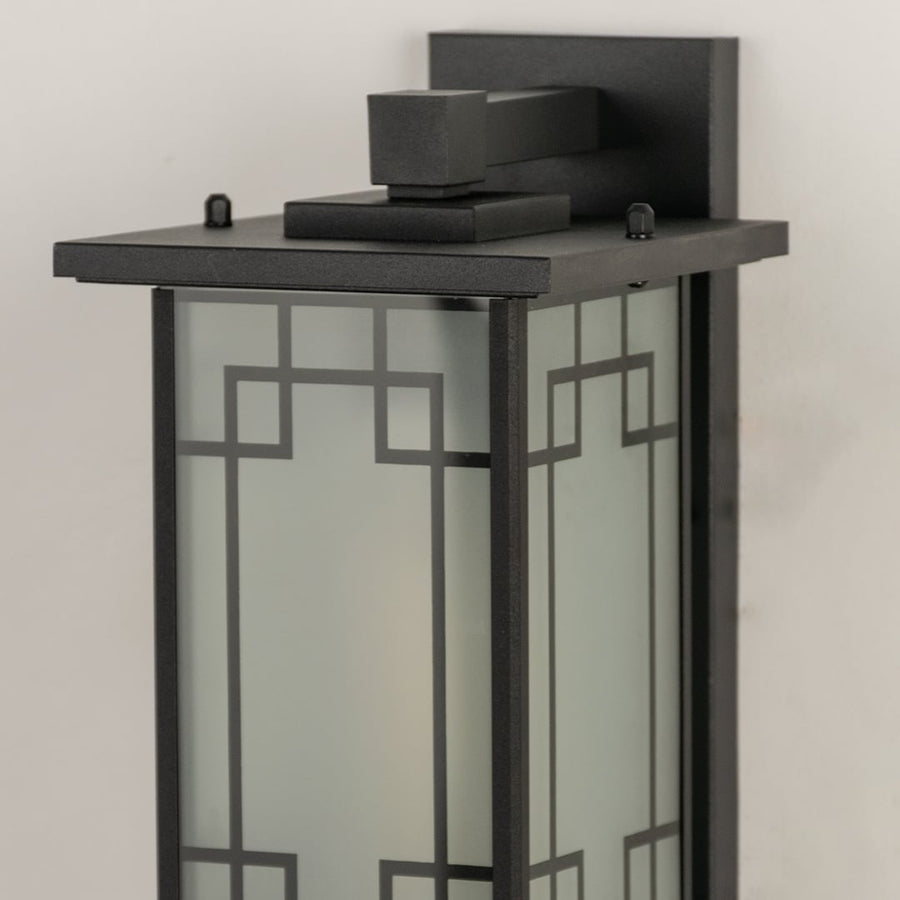 Closeup of gold outdoor lantern showing decorative glass detailing and textured metal frame ideal for classic outdoor porch patio and entryway lighting.