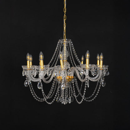 Chandelier with gold detailing and crystal accents displayed off against black background for decor style.