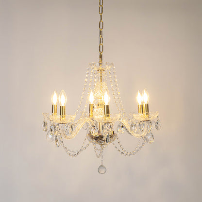 Clear crystal chandelier with illuminated candle bulbs and sparkling crystal drops creating luxurious traditional ceiling lighting.