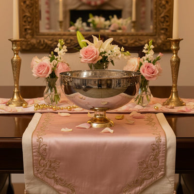 Gold metal decorative bowl lifestyle image with floral arrangement for elegant classic dining table decor.