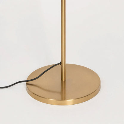 Closeup image of linear gold metal floor lamp base for elegant living room decor styling and modern home lighting design.