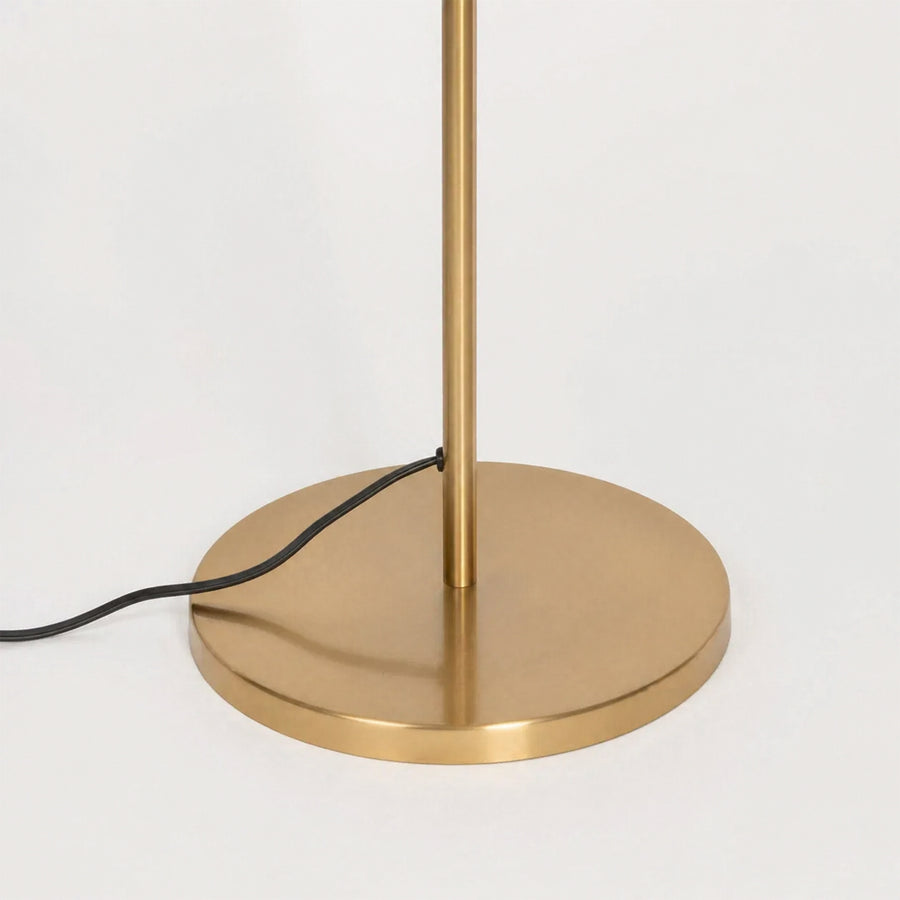 Closeup image of linear gold metal floor lamp base for elegant living room decor styling and modern home lighting design.