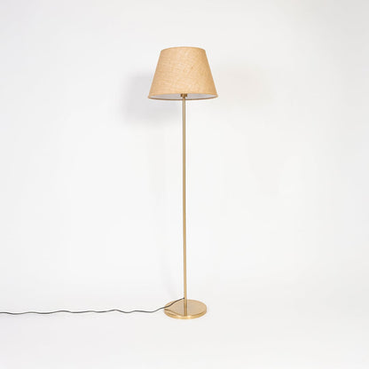 Beige shade floor lamp with golden base displayed with light off against white background.