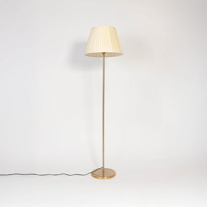 Golden floor lamp with pleated white fabric shade displayed turned off on plain white background.