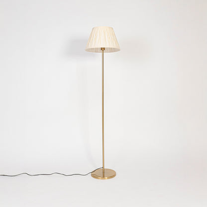 Floor lamp with white pleated fabric shade and golden stand displayed on white background with light off.