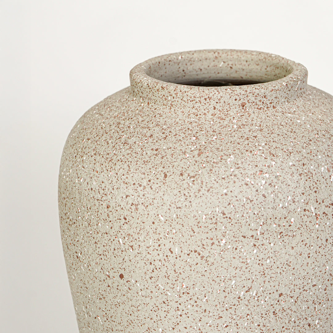Closeup image of beige ceramic rustic vase for modern tabletop decor styling with textured matte finish.