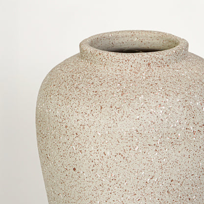 Closeup image of beige ceramic rustic vase for modern tabletop decor styling with textured matte finish.