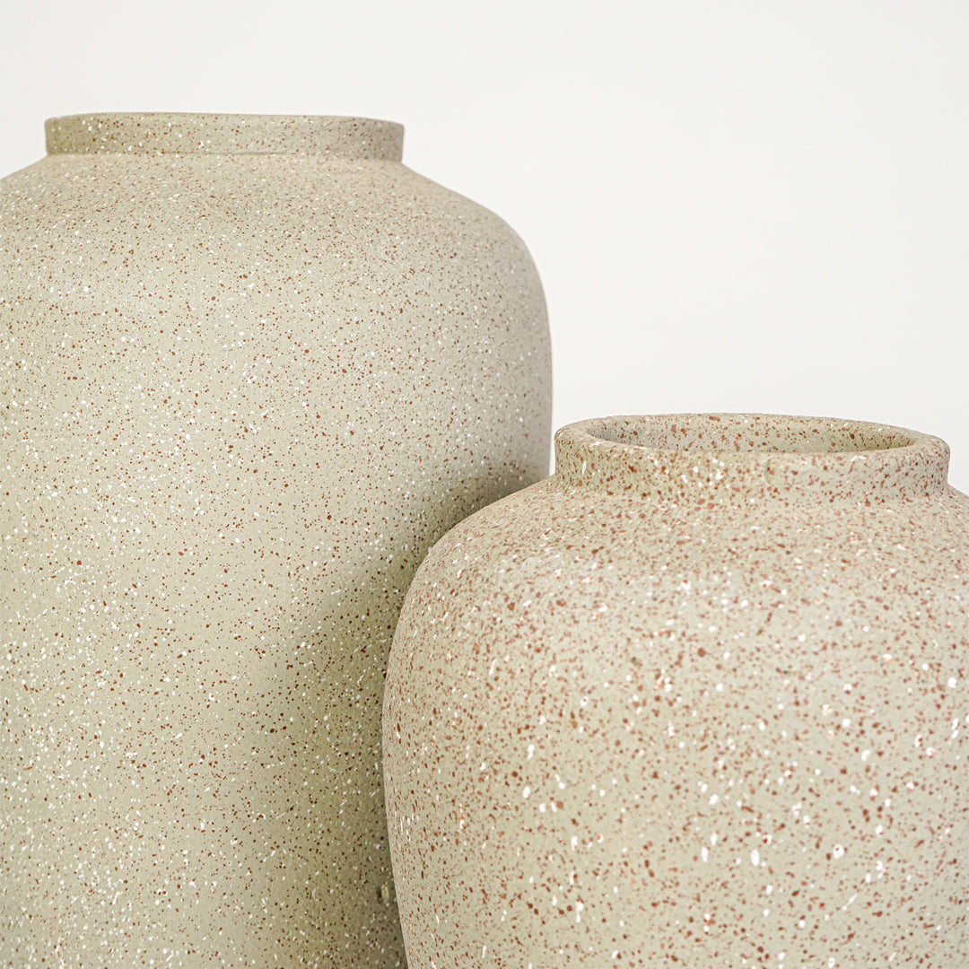 Closeup image of beige ceramic decorative vase set for modern interior styling with rustic textured finish.