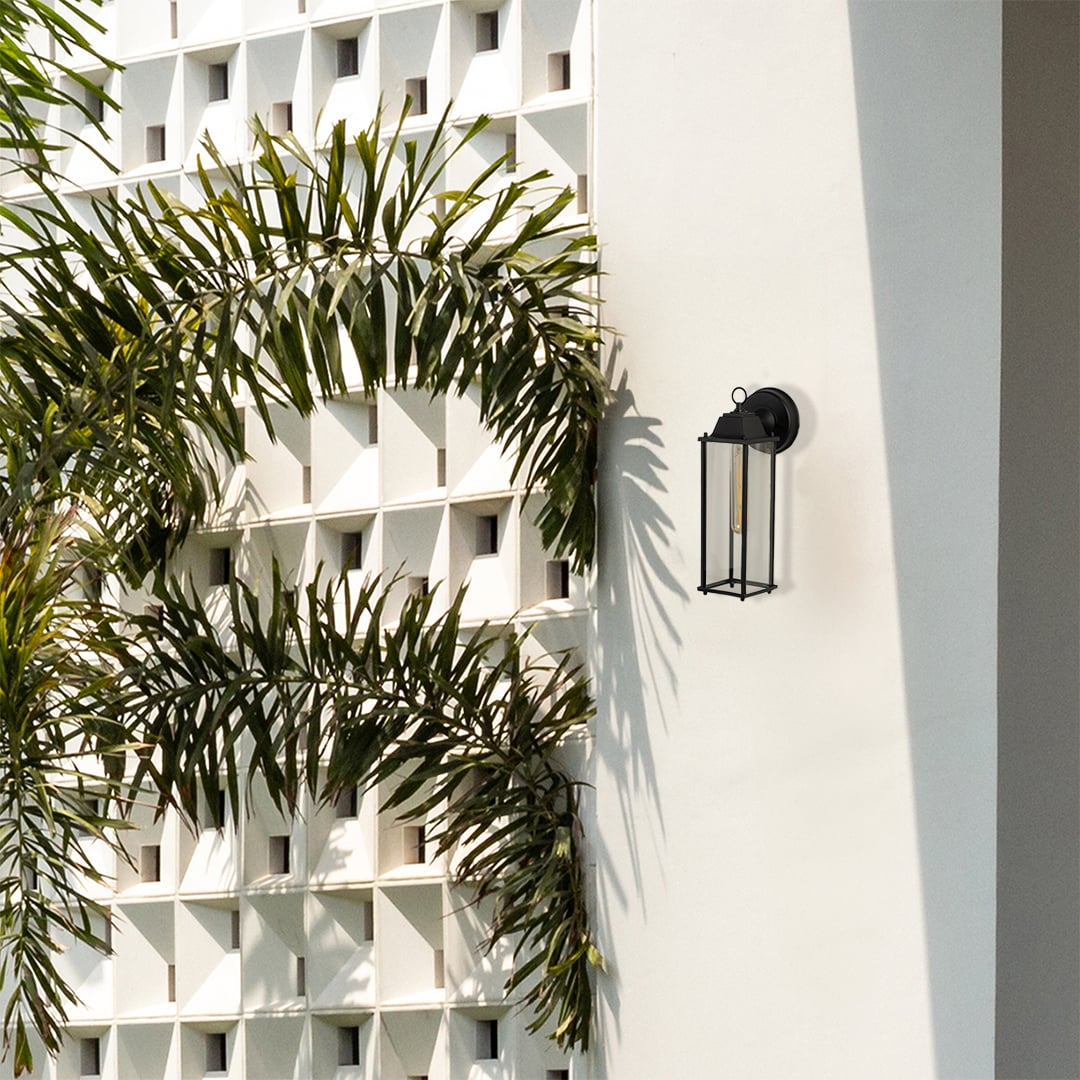 Modern outdoor wall lantern showcased in a clean lifestyle setting highlighting its sleek black frame and clear glass panels.