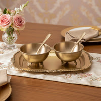 Gold metal condiment bowl set lifestyle image with serving spoons for elegant luxury dining table decor.