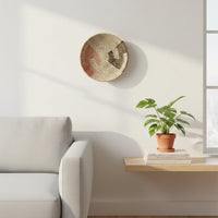 Natural woven wall basket displayed above a side table for elegant bohemian wall decor and modern home interiors.
