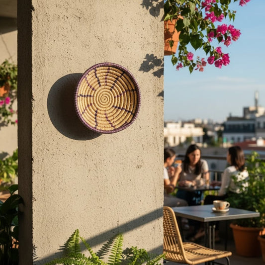 Handwoven round wall basket Decor styled on an outdoor cafe wall with natural sunlight greenery and people in the background creating a relaxed boho lifestyle ambiance.