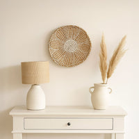 Lifestyle image of medium white handwoven sabai grass hanging wall basket for elegant modern living room decor styling.