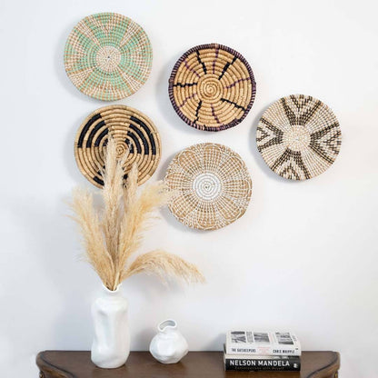 Handwoven seagrass wall basket decor set in natural beige with colorful woven designs for elegant boho home wall styling.