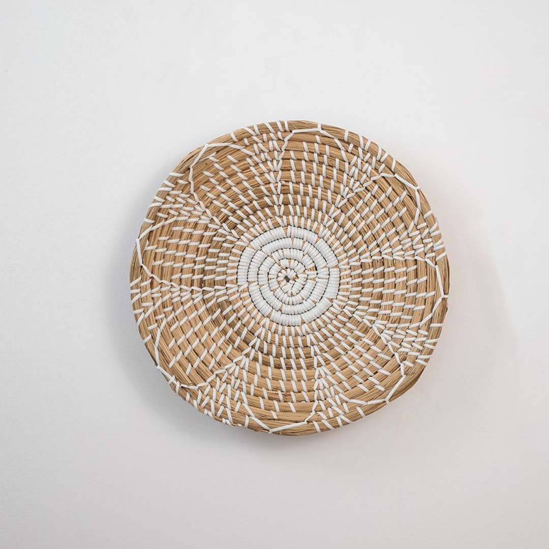 Natural handcrafted woven wall basket with radial pattern for minimalist wall styling and modern home decor.