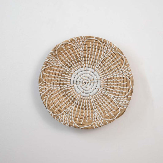 Natural handcrafted woven wall basket with radial pattern for minimalist wall styling and modern home decor.