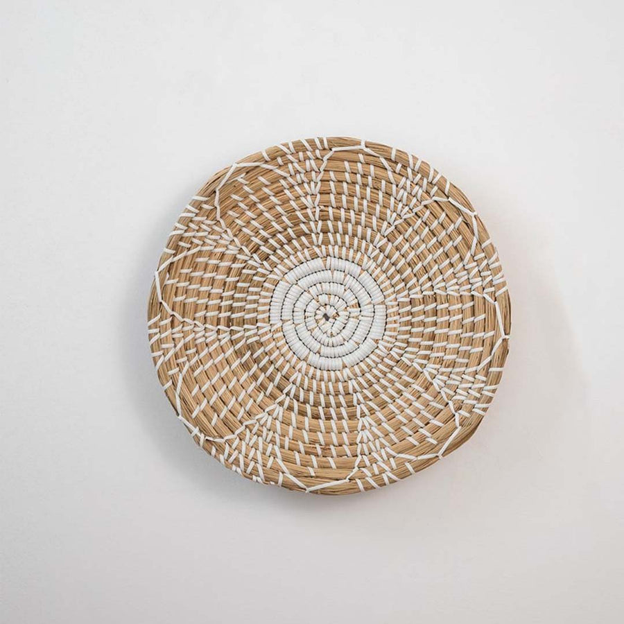 Natural handcrafted woven wall basket with radial pattern for minimalist wall styling and modern home decor.