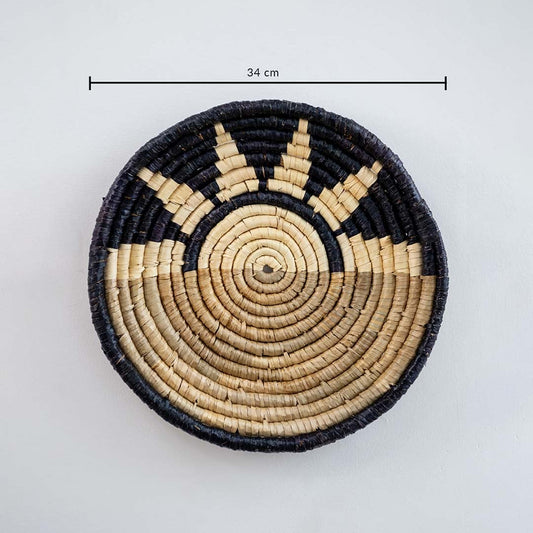 Handwoven sabai grass wall basket in black and beige measuring 34 cm diameter showing detailed weave ideal for boho interior wall decor.