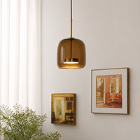 Lifestyle image of round shade sunbeam glass pendant light for elegant dining room decor styling and modern home lighting.