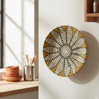Handcrafted round wall decor with detailed geometric pattern mounted near window adding warm sunlight effect and artistic home decor appeal.