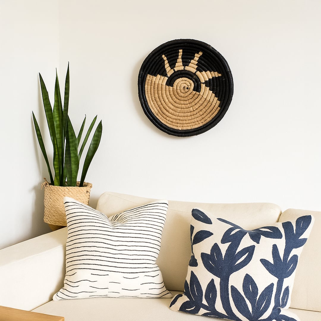 Decorative woven wall basket styled above sofa with cushions and plant bringing natural warmth to stylish interior Decor.