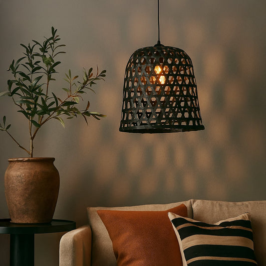Woven black rattan pendant light creating a warm ambient glow and adding natural charm to modern living spaces.