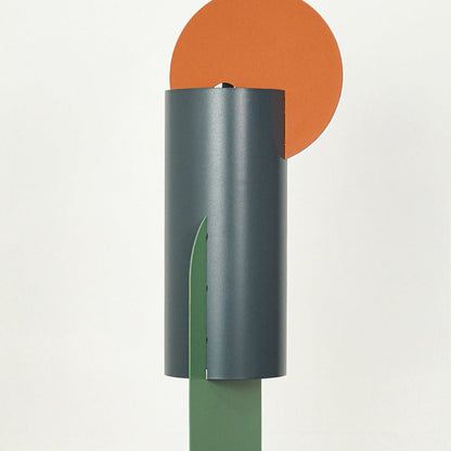 Closeup of charcoal metal pendant light highlighting orange and green accents with premium finish.