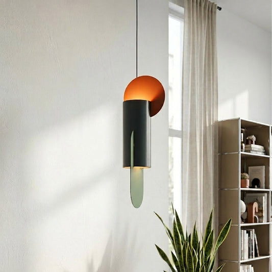 Stylish pendant light with green and orange metal shades placed near window with indoor plant perfect for modern home decor lighting setup.

