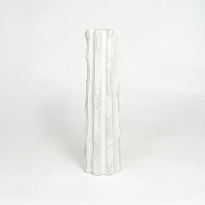 Modern white ceramic statement floor vase with minimalist textured finish for luxury home interiors.