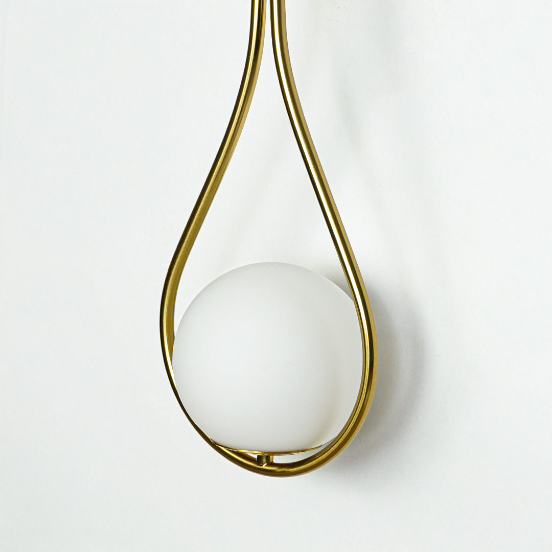 Closeup of white glass and gold metal wall light for modern hallway and premium decor styling spaces.