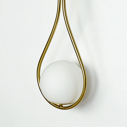 Closeup of white glass and gold metal wall light for modern hallway and premium decor styling spaces.