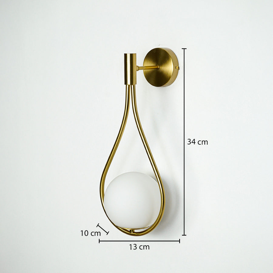Gold metal wall light with 34 cm height 13 cm width and 10 cm depth for modern decor spaces.
