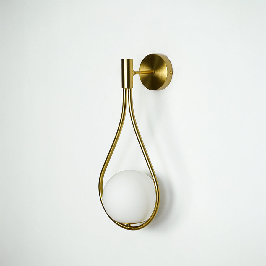 Modern gold metal wall light with white glass globe for elegant hallway and luxury decor styling spaces.