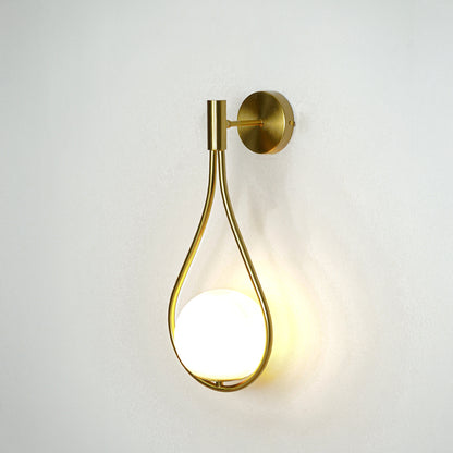 Modern gold metal wall light with warm ambient glow for stylish bedroom and luxury decor spaces.

