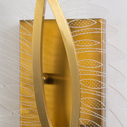 Closeup of gold wall light with sculpted acrylic panels highlighting artistic curves and premium textured finish.