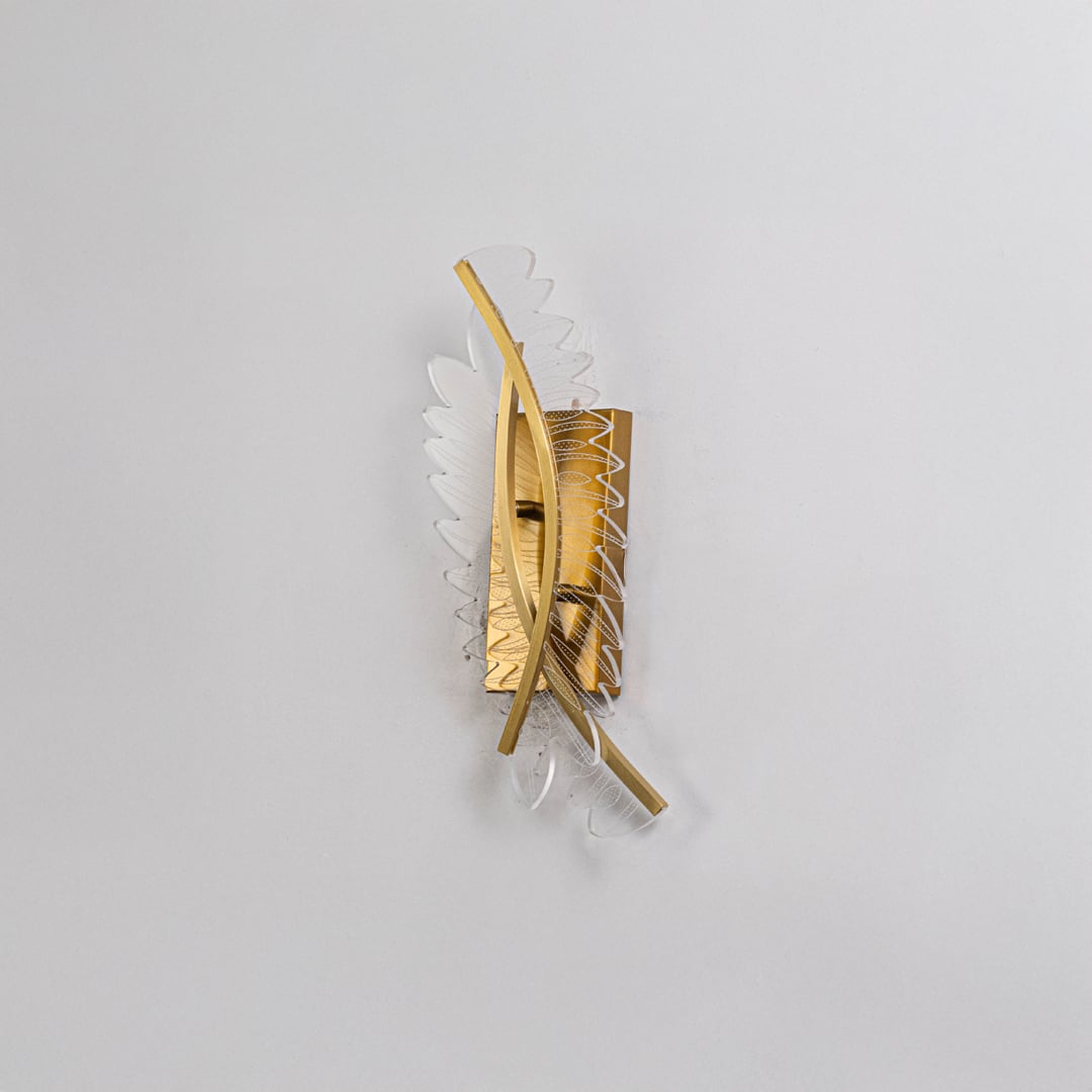 Gold wall light with sculpted acrylic panels shown on a bright white background with lights off for product clarity.