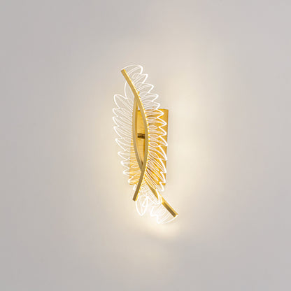 Decorative wall light in gold metal finish with artistic pattern for bedroom or living room decor lighting white background.