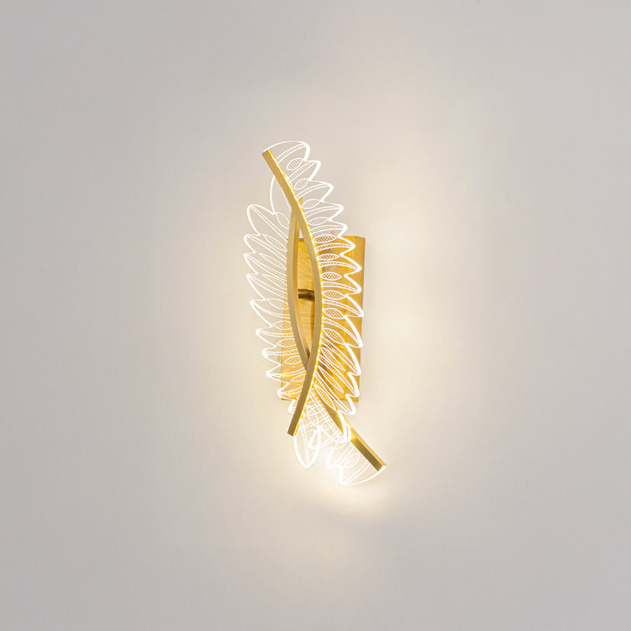 Decorative wall light in gold metal finish with artistic pattern for bedroom or living room decor lighting white background.