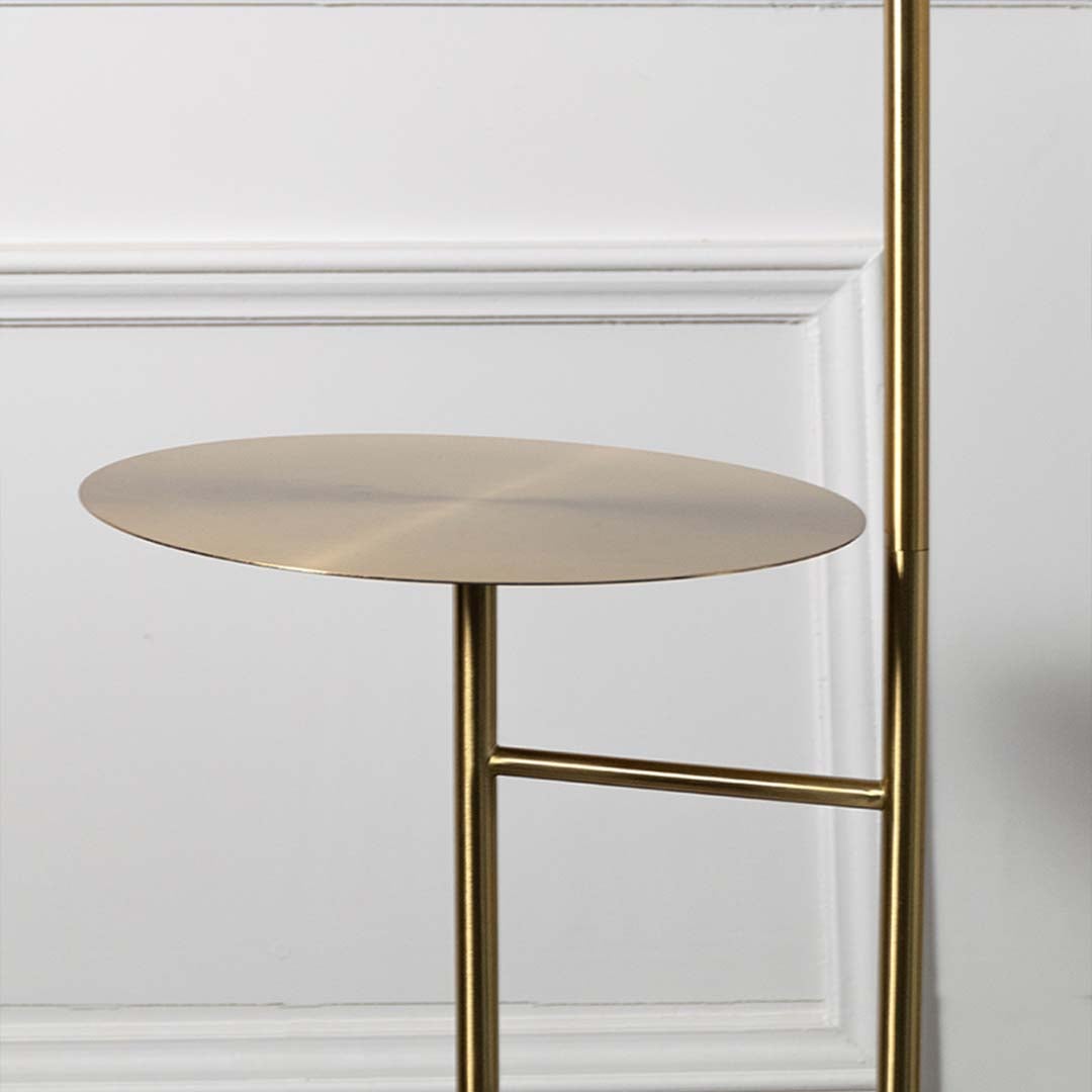 Closeup of gold floor lamp shade with metallic finish showing sleek and elegant design.