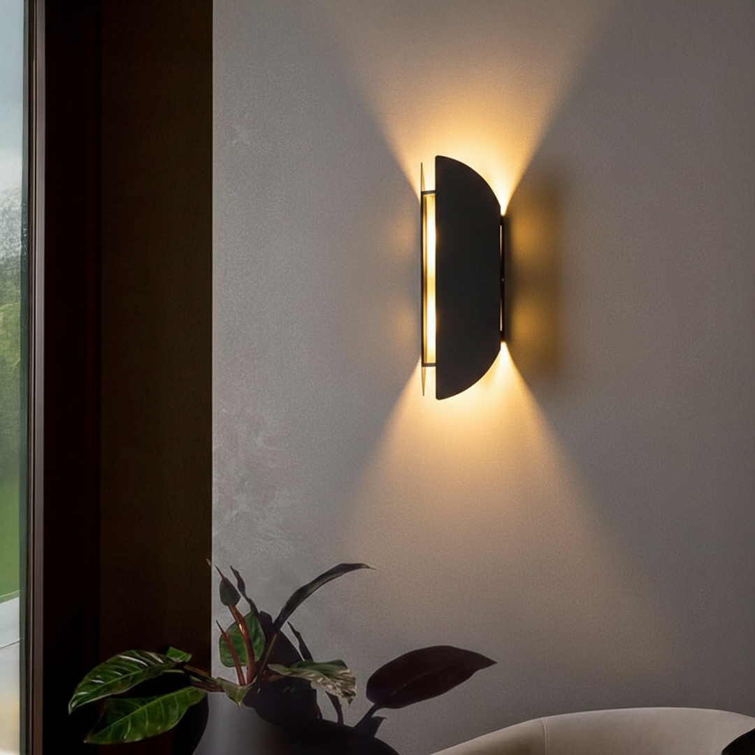 Wall light styled on textured grey wall beside window and indoor plant casting warm upward glow for modern luxury Decor ambience.