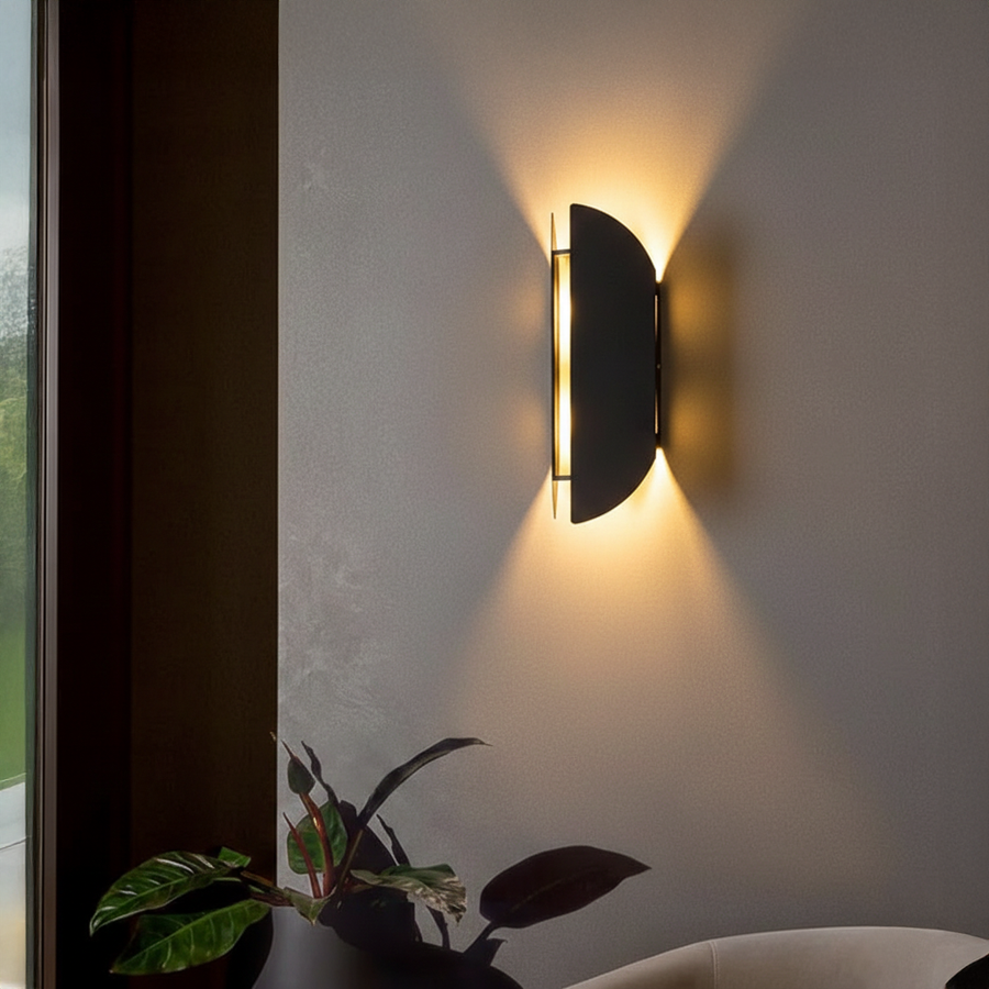 Wall light styled on textured grey wall beside window and indoor plant casting warm upward glow for modern luxury Decor ambience.
