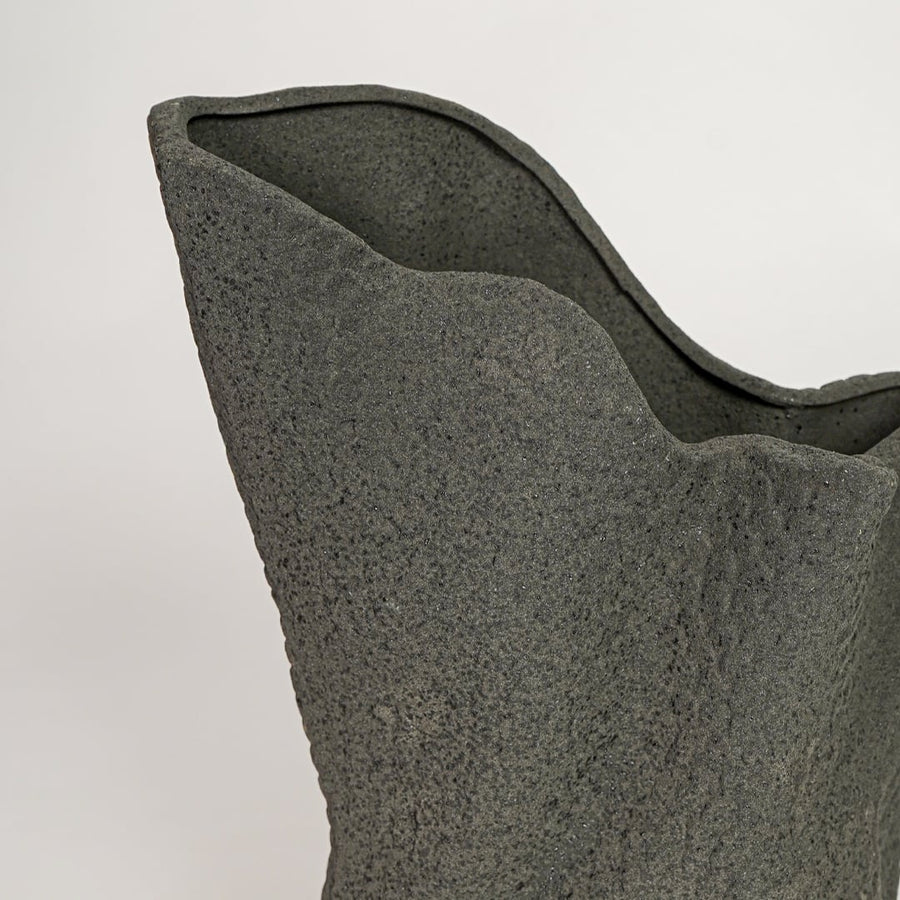 Black ceramic decorative vase with textured stone finish and sculpted organic form perfect for elegant dried floral display.